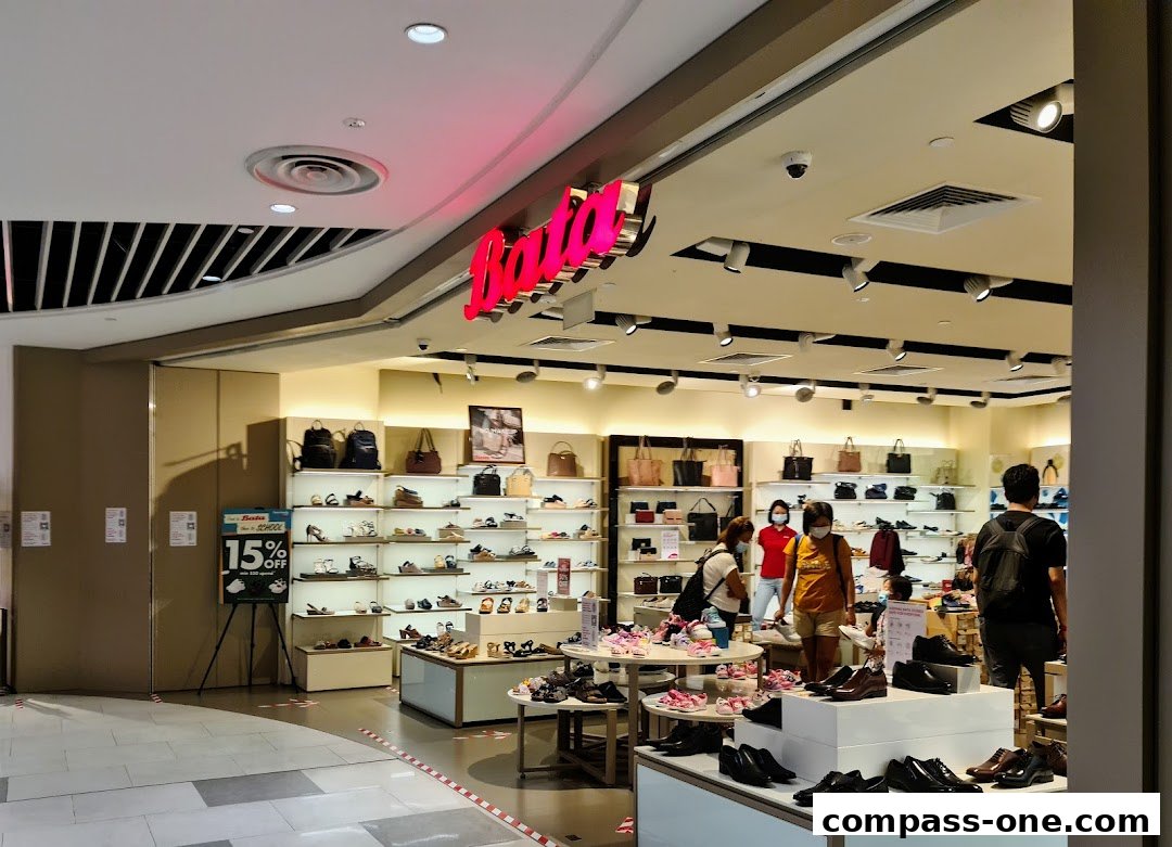 Interior view of a Bata shoe store showcasing various footwear and handbags on display.