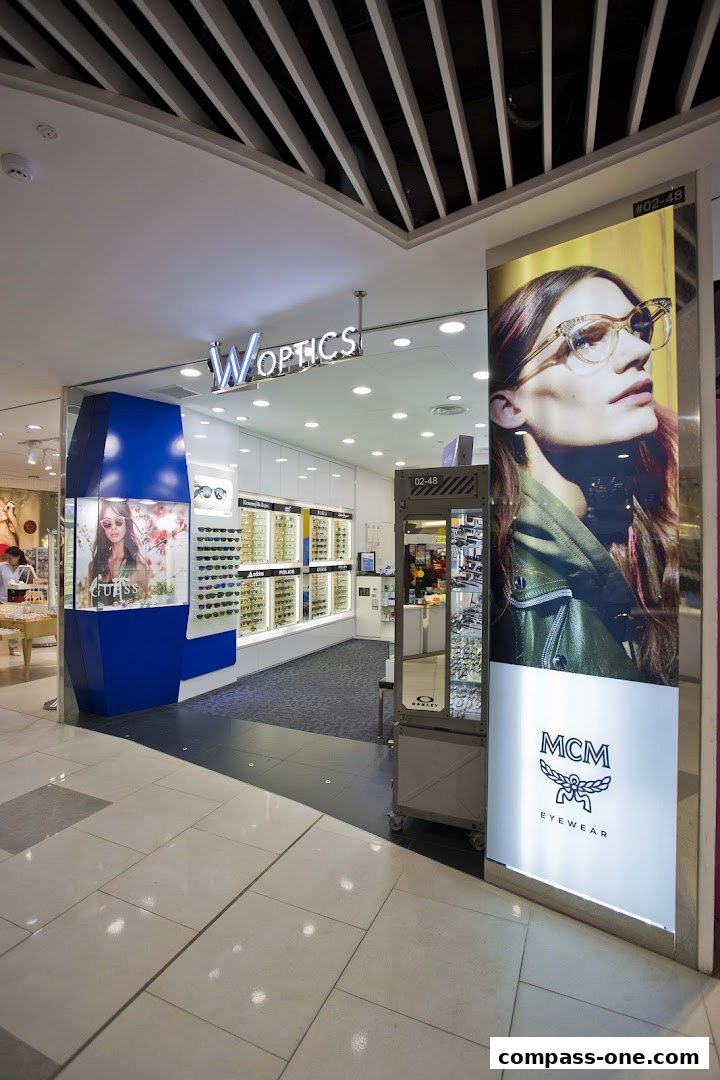 The W Optics store features a modern facade with a large display of eyeglasses and a prominent advertisement.