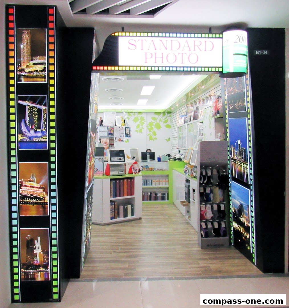 The entrance to Standard Photo, a shop with film strip displays and interior showcasing photo services.