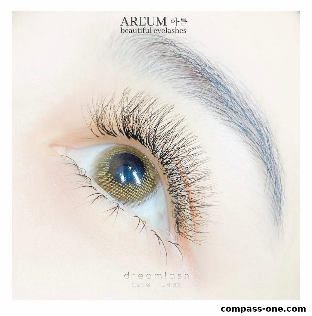 Close-up of a beautiful eye with long, voluminous eyelashes and a golden contact lens.