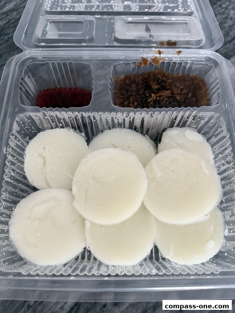 A takeaway container filled with Shui Kueh and two side condiments.