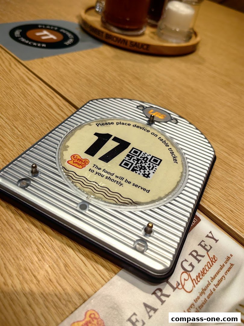 A table tracker with number 17 and a QR code, next to a dessert menu.