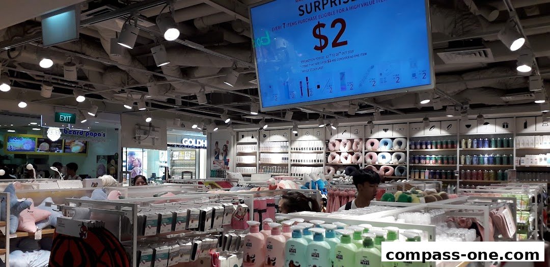 Interior view of a MINISO store showcasing various products and a promotional display.