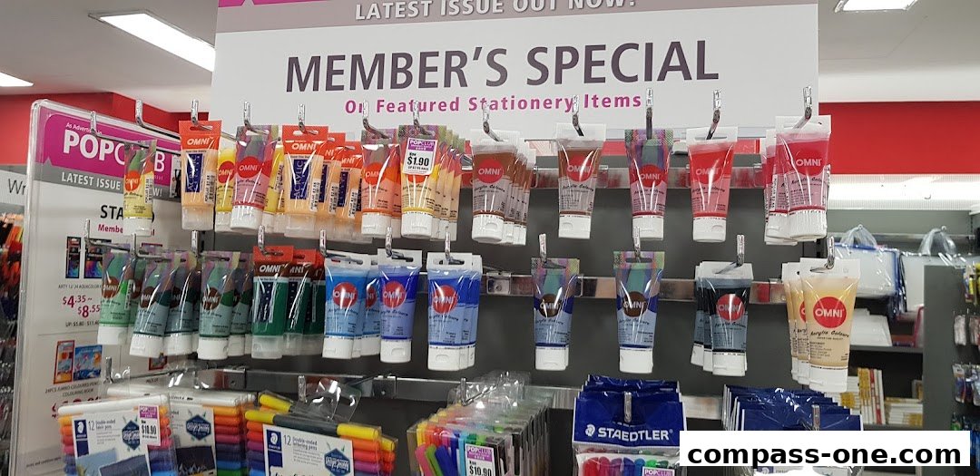 A display of OMNI acrylic paints and STAEDTLER pens on shelves at POPULAR Bookstore.