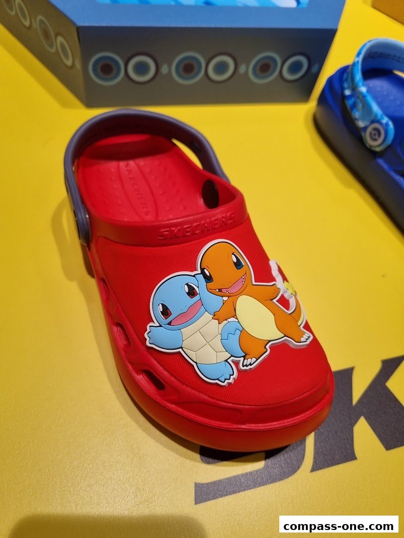 A red Skechers clog decorated with popular Pokémon characters Squirtle and Charmander.
