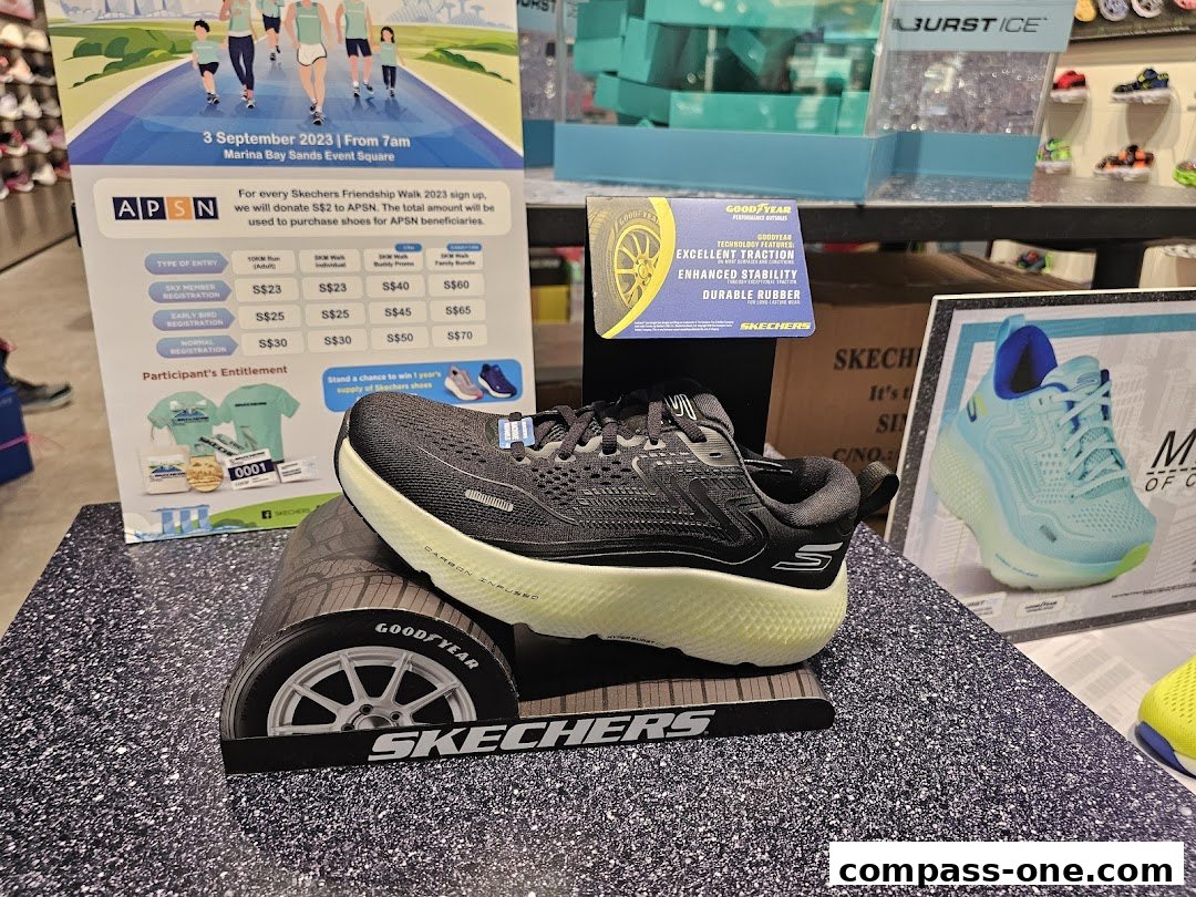 Skechers shoes displayed with promotional materials for a Friendship Walk event.