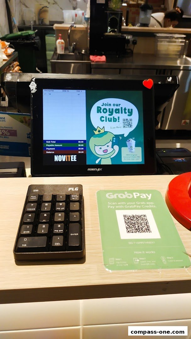 A payment terminal at Coconut Queen with a promotion for their Royalty Club and GrabPay payment option.