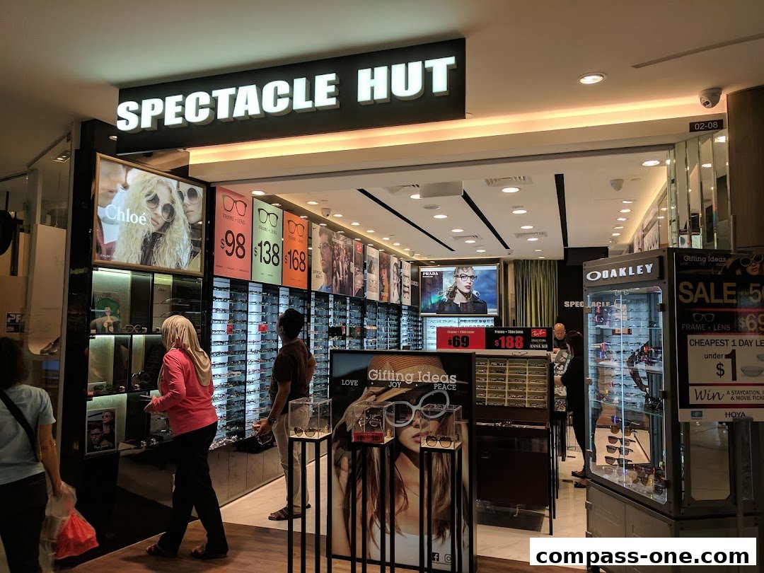 Spectacle Hut shop interior with displays of glasses and promotional signage.