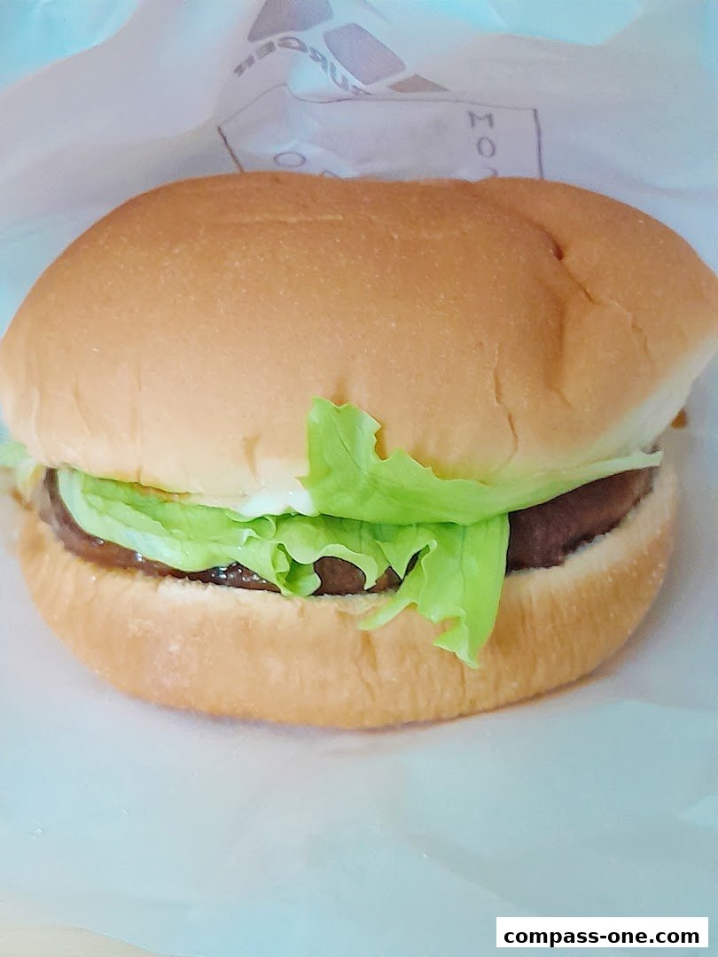 A close-up shot of a delicious MOS Burger with fresh lettuce and a soft bun.