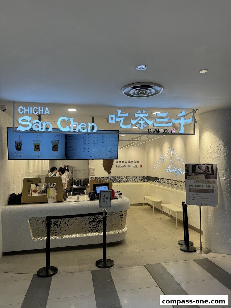 The entrance of CHICHA San Chen, a bubble tea shop, with its illuminated signage and counter.