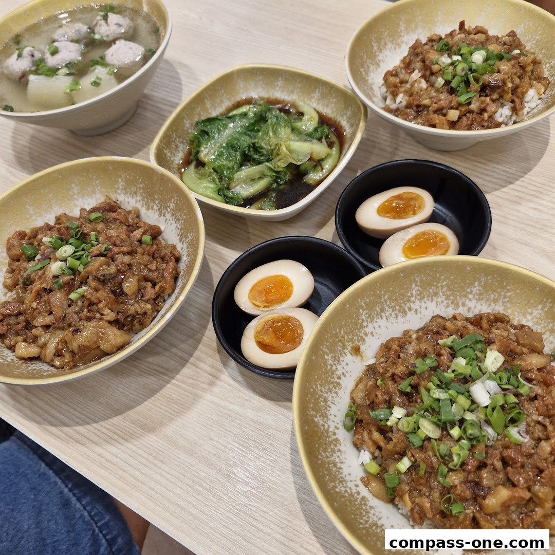A spread of Taiwanese comfort food, featuring braised pork rice bowls, soup, and braised eggs.