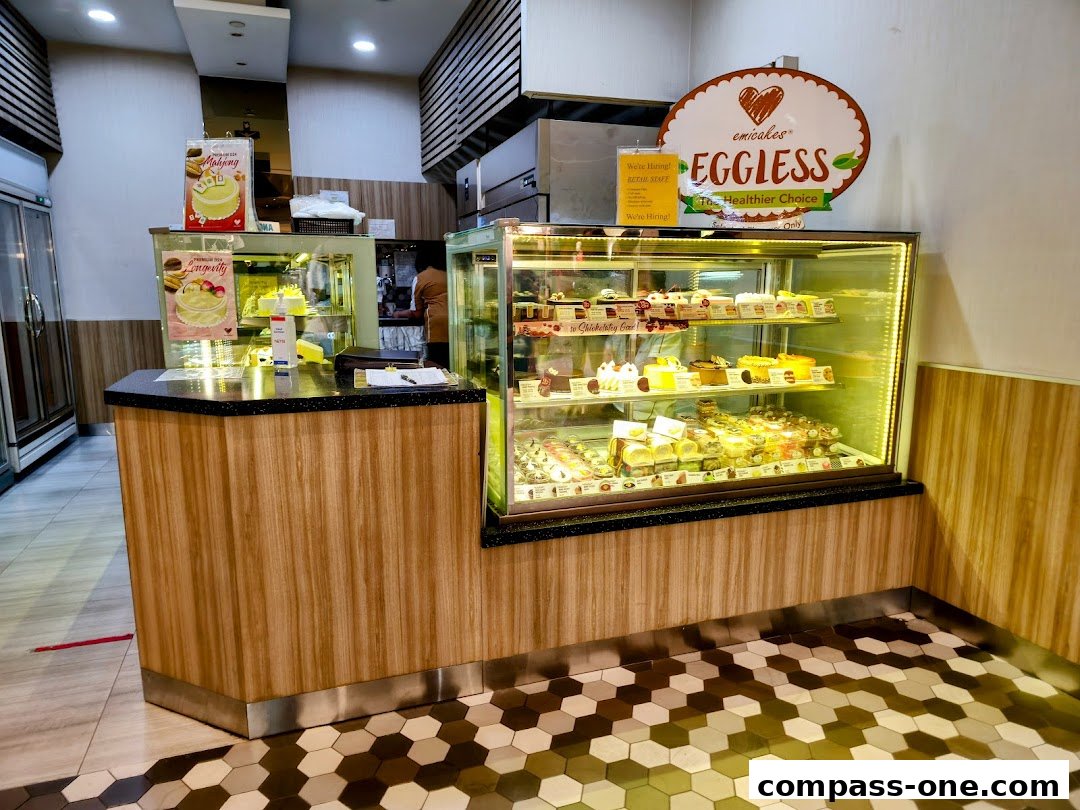 A display counter filled with various cakes and pastries at Emicakes.