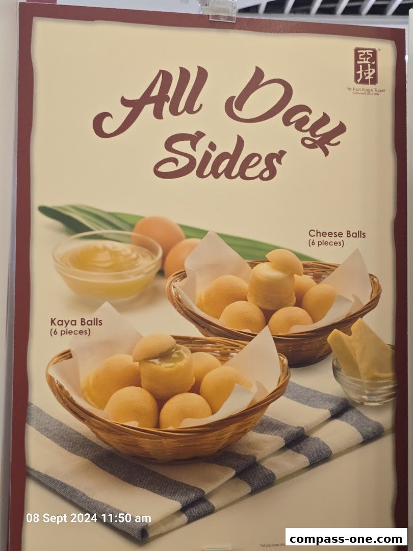 A sign advertising Ya Kun Kaya Toast's 'All Day Sides' featuring Kaya Balls and Cheese Balls.