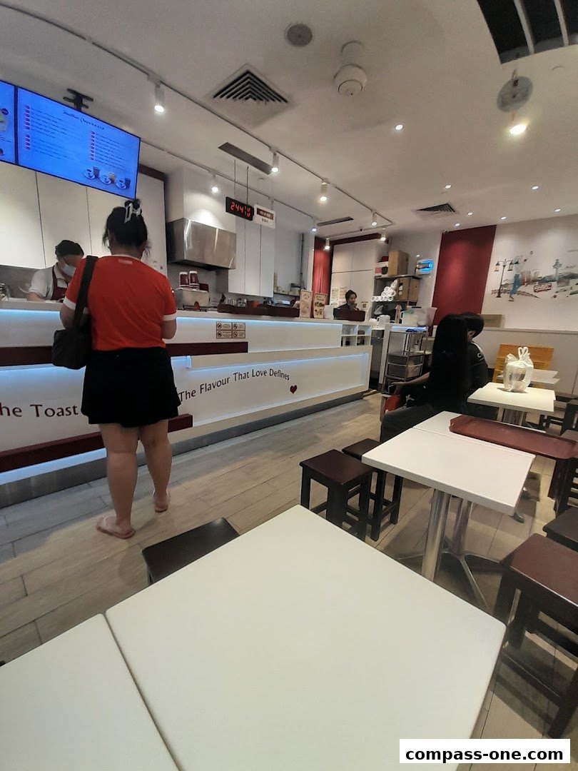 Interior view of Ya Kun Kaya Toast with customers ordering and seated.