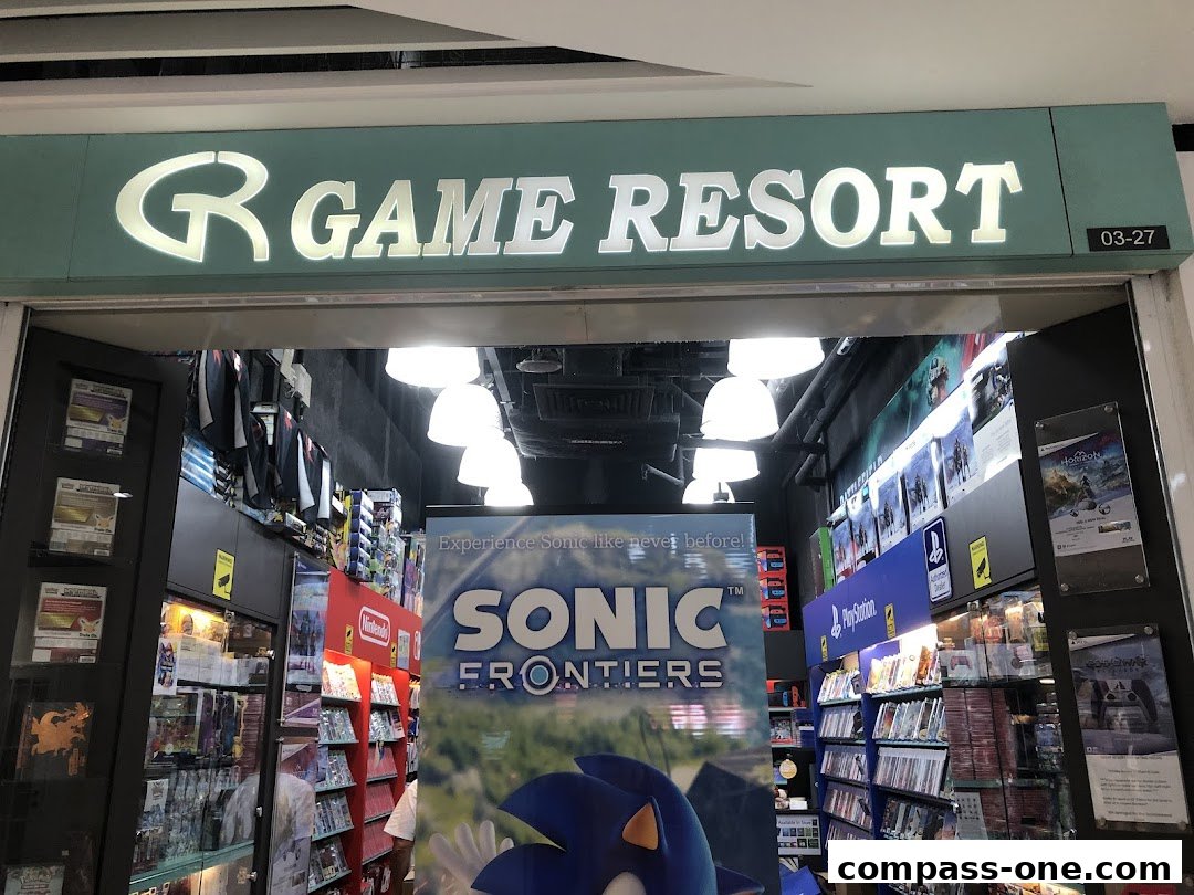 The entrance of Game Resort, a video game store, showcasing game displays and merchandise.