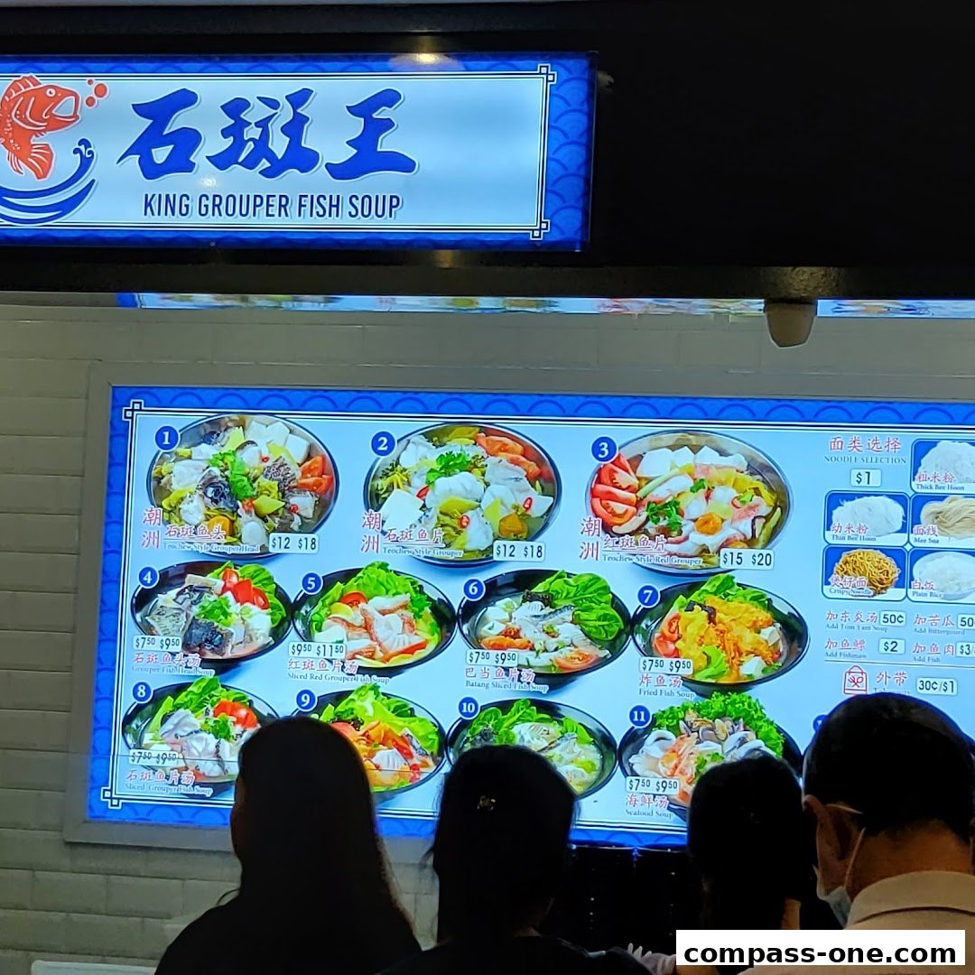 A menu board displays various fish soup dishes with prices and images.