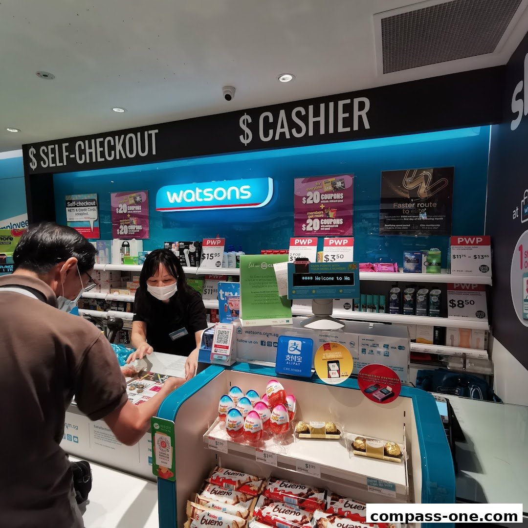 A Watsons store checkout counter with self-checkout and cashier stations, displaying various promotions and products.