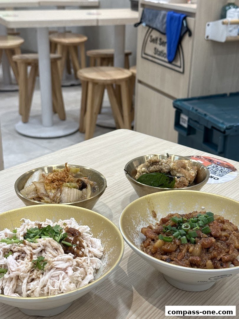 Four bowls of delicious Taiwanese braised meat rice and shredded chicken rice are displayed on a table.