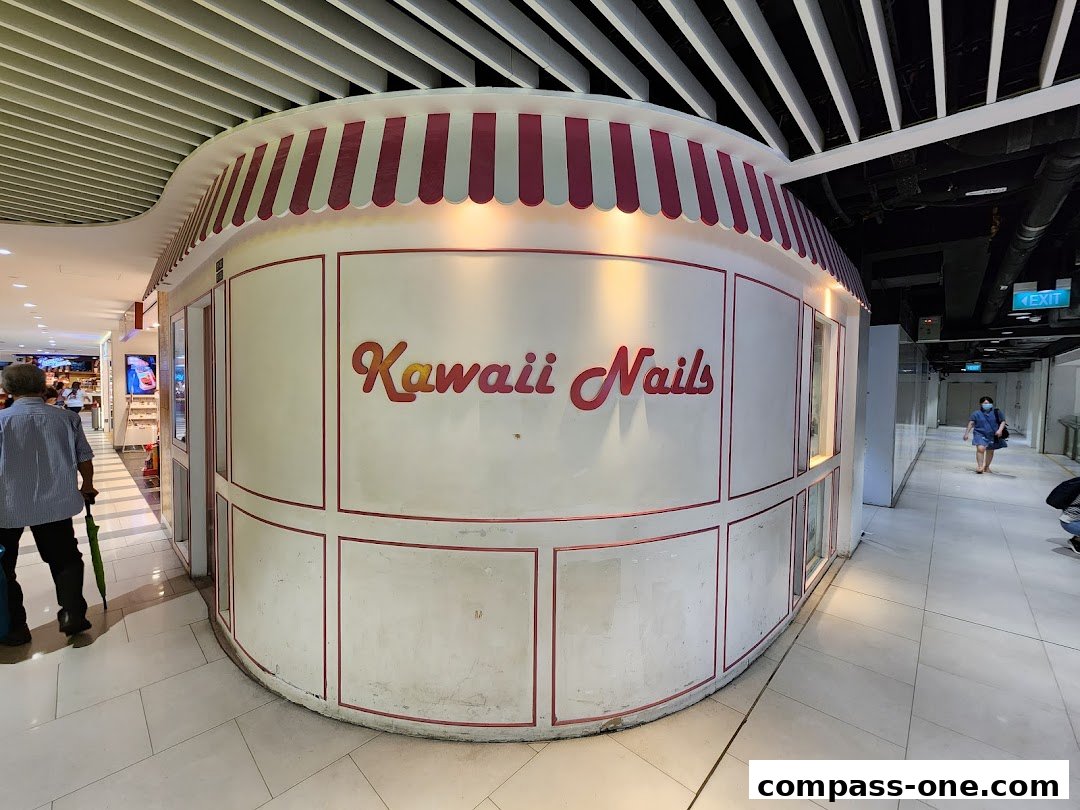 The exterior of a nail salon named Kawaii Nails with a striped awning.