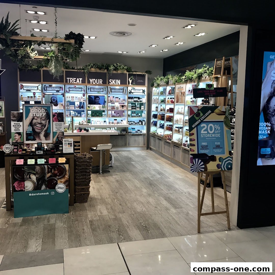 Interior view of The Body Shop store showcasing skincare products and a promotional sign.