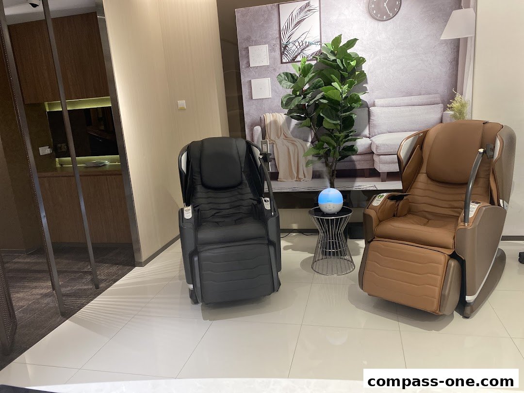Two massage chairs, one black and one brown, are displayed in a modern retail space.