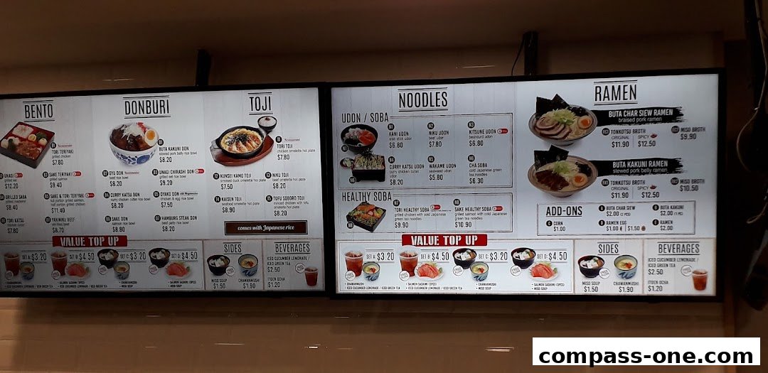 A brightly lit menu board displaying various Japanese food categories like Bento, Donburi, Toji, Noodles, Ramen, Sides, and Beverages.