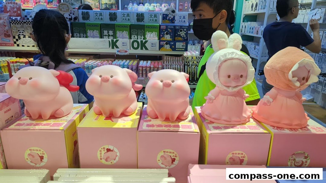 Cute pig figurines dressed in pink outfits displayed on boxes in a retail store.
