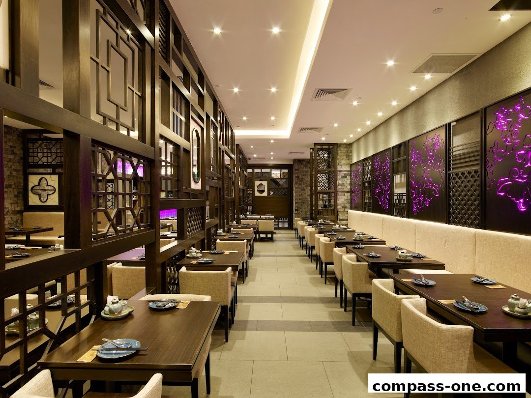 Interior view of a modern Chinese restaurant with elegant wooden decor and purple accents.