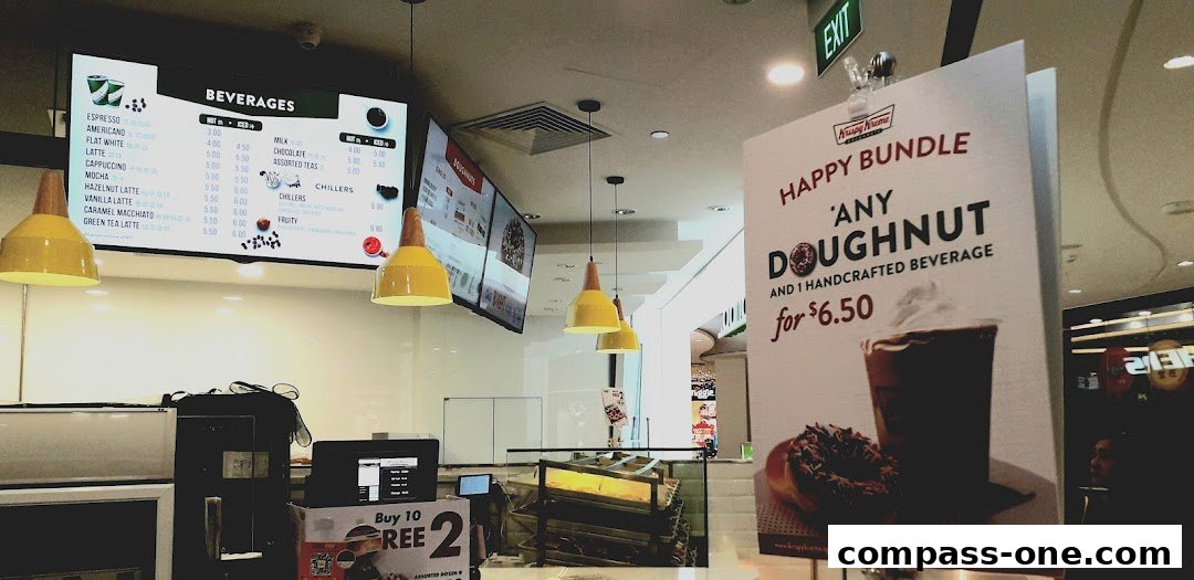 A Krispy Kreme shop interior with a beverage menu and a promotional poster.