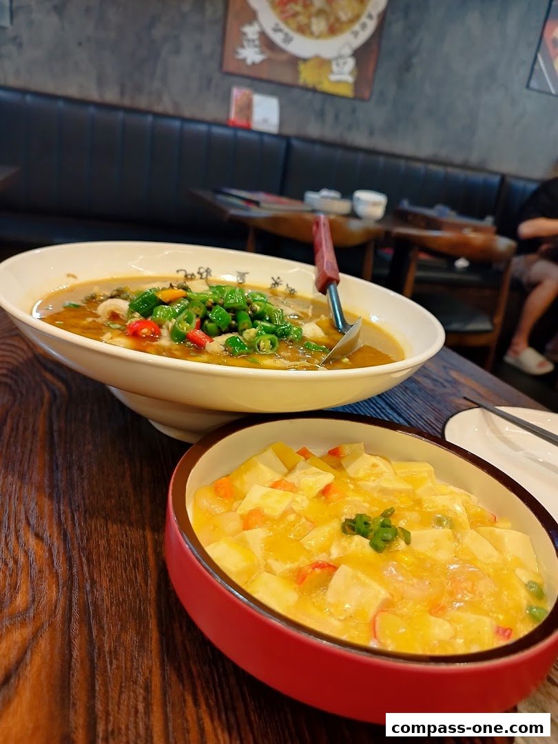 Two bowls of delicious Chinese food, one with fish and peppers, the other with tofu and vegetables.