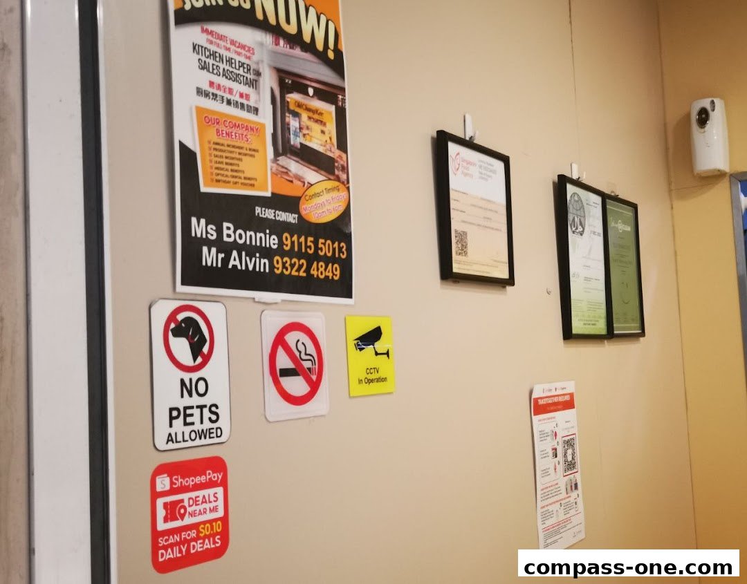 A wall with various signs including job vacancies, no pets, no smoking, CCTV, and ShopeePay deals.