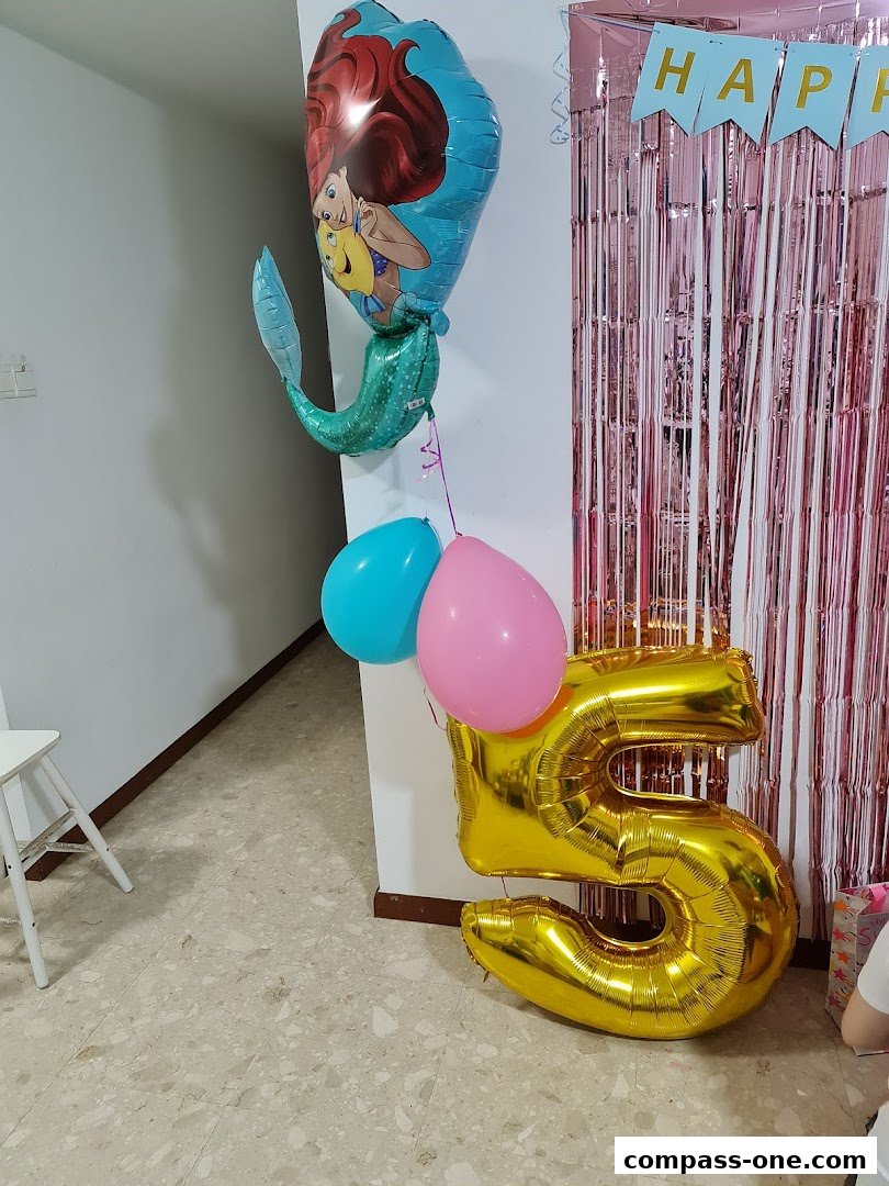 Ariel-themed balloons and a large number '5' balloon for a birthday party.