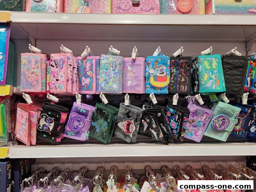 A display of colorful Smiggle wallets and purses with various fun designs and characters.