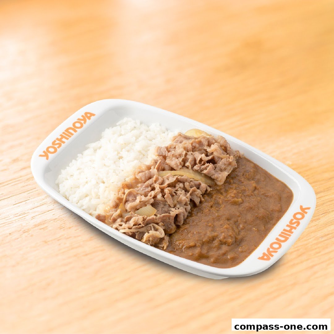 A Yoshinoya dish featuring rice, beef, and curry on a white plate.