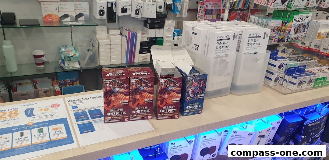 A retail store display featuring One Piece card games, masks, and various electronic accessories.