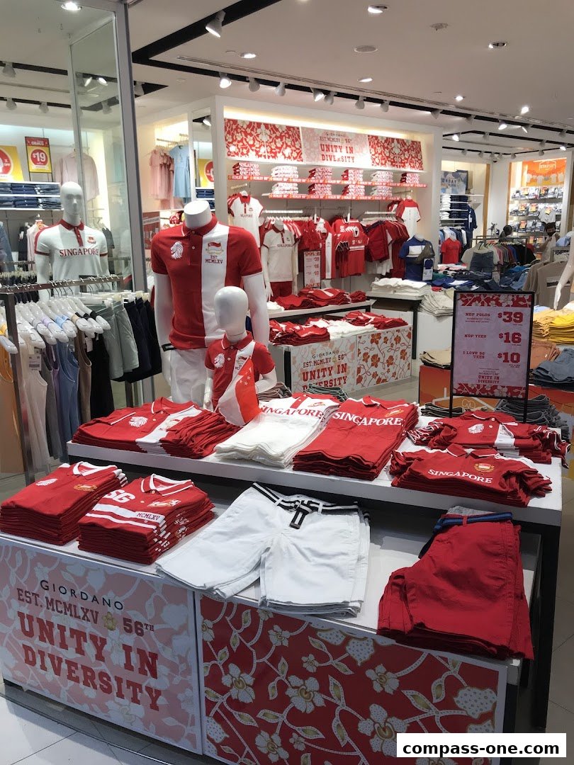 Giordano shop interior displaying red and white apparel with Singapore-themed designs.