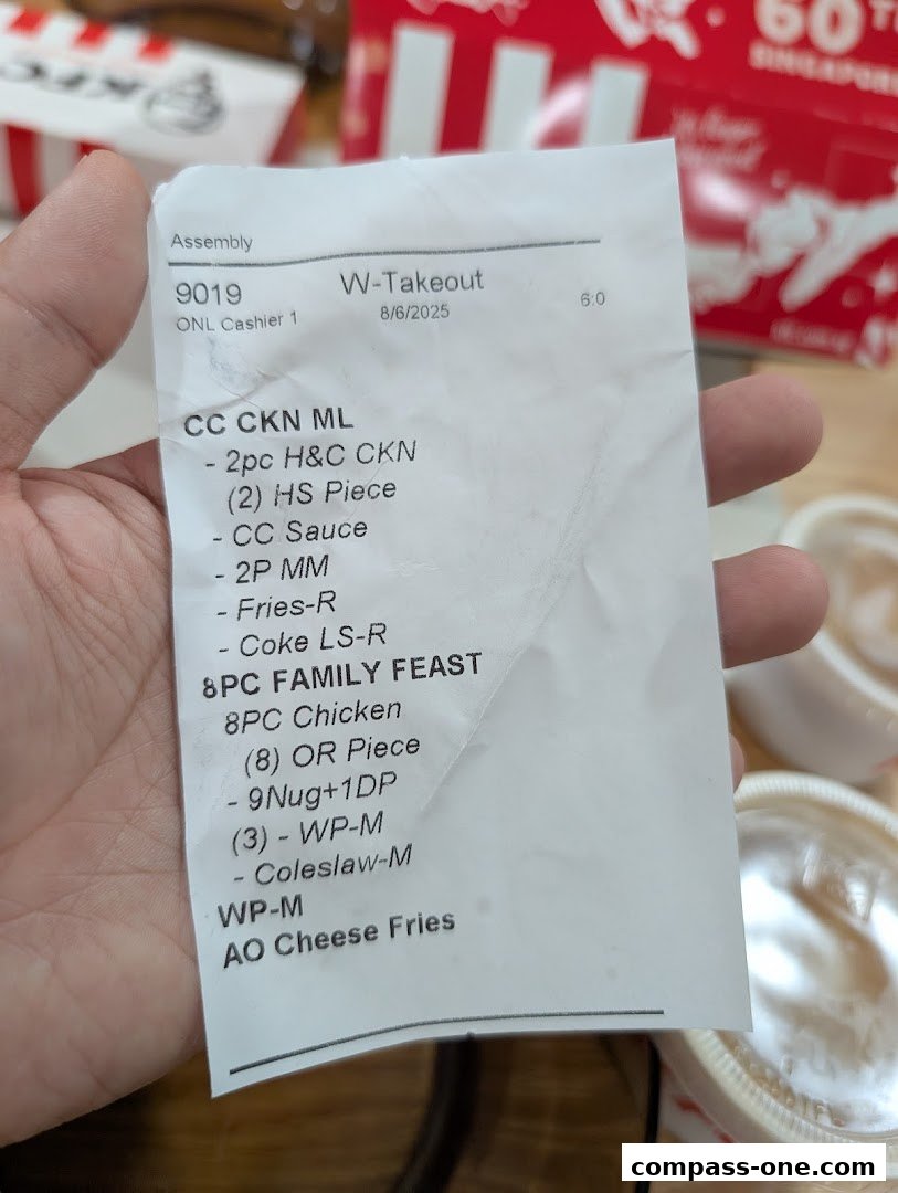 A receipt from KFC showing a takeout order with chicken, fries, and drinks.