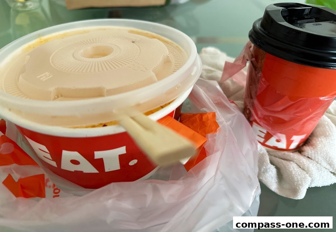 A to-go container of food and a beverage cup from EAT.