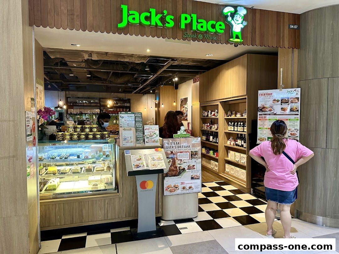 The exterior of Jack's Place restaurant, showcasing a display of cakes and a menu board.