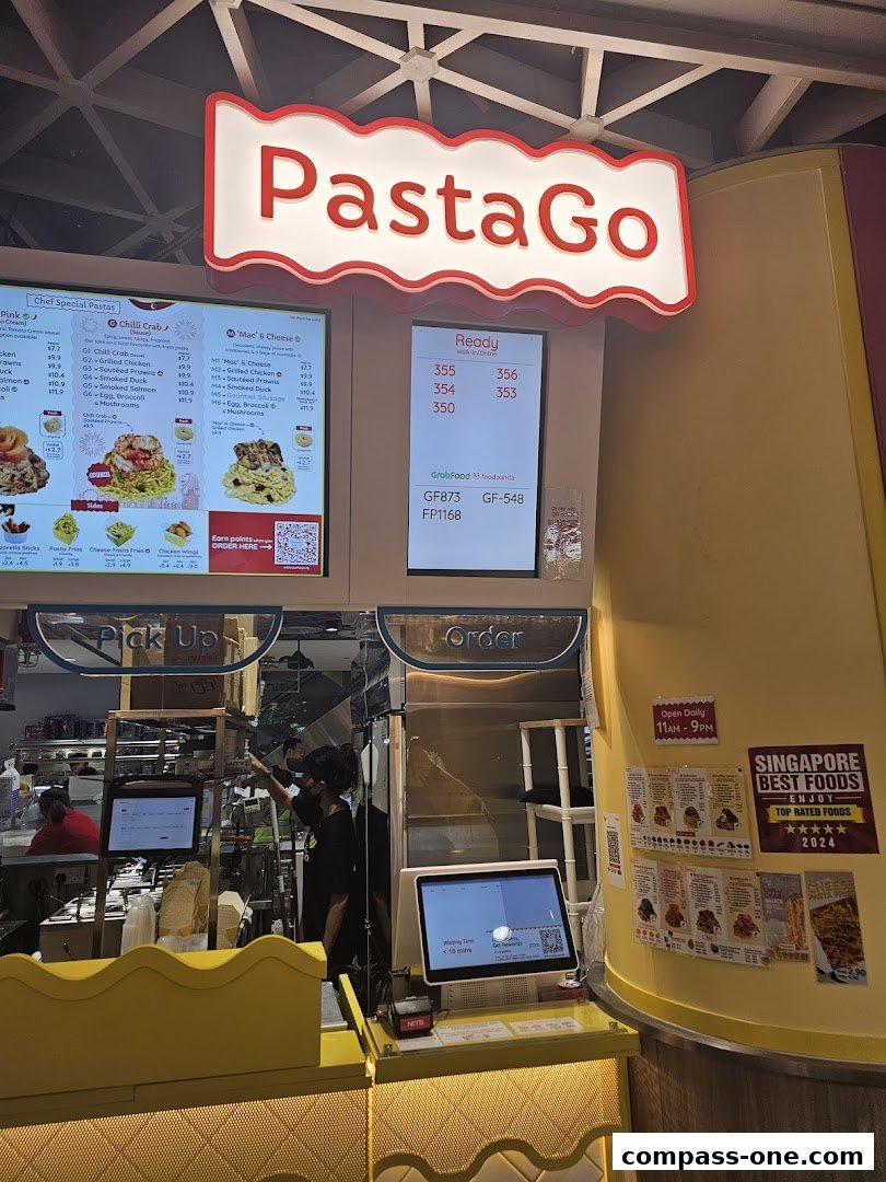 A PastaGo shop with a menu board, order counter, and staff preparing food.