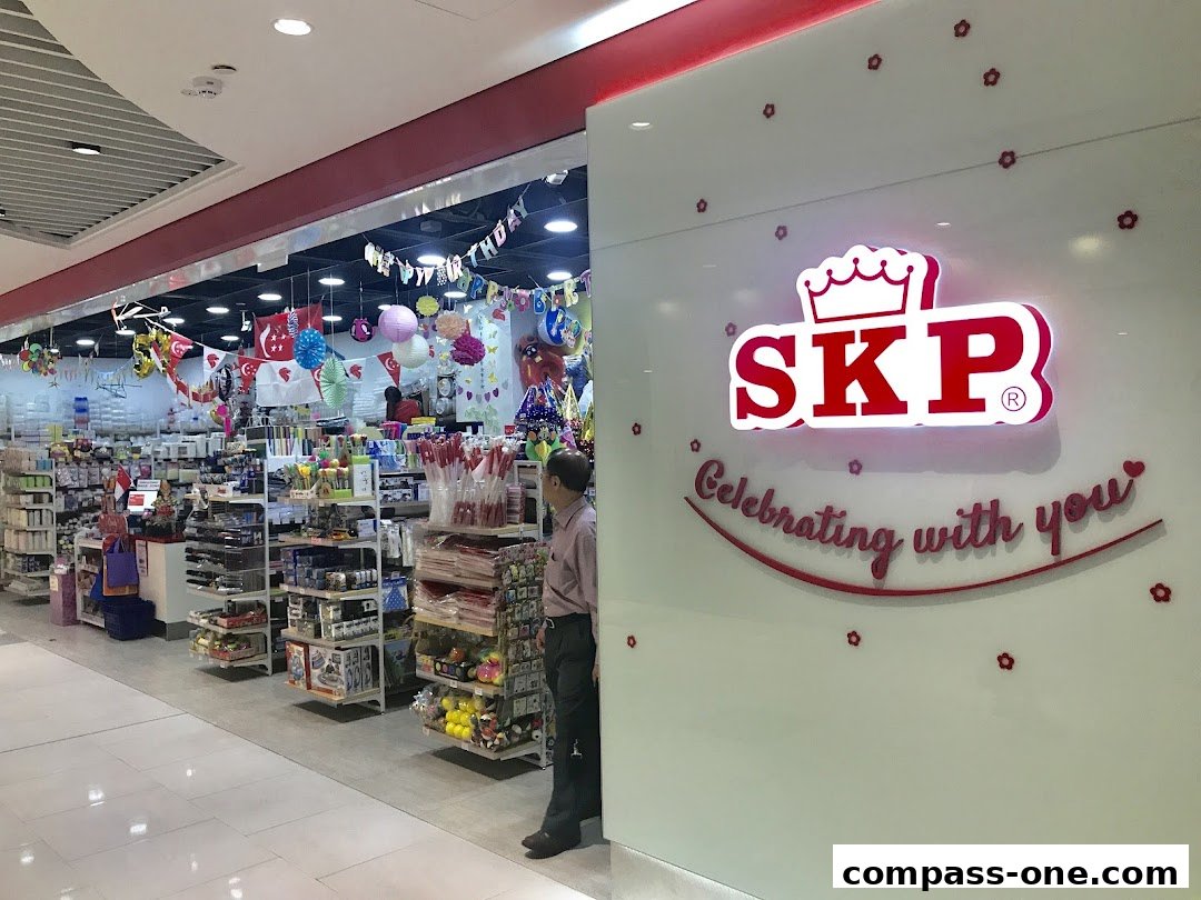 The entrance of SKP, a shop selling party supplies and gifts, decorated with balloons and banners.