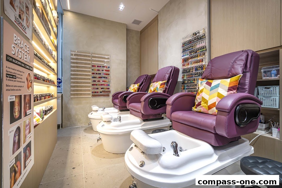 Interior of a nail spa with pedicure chairs, nail polish displays, and a brace system poster.
