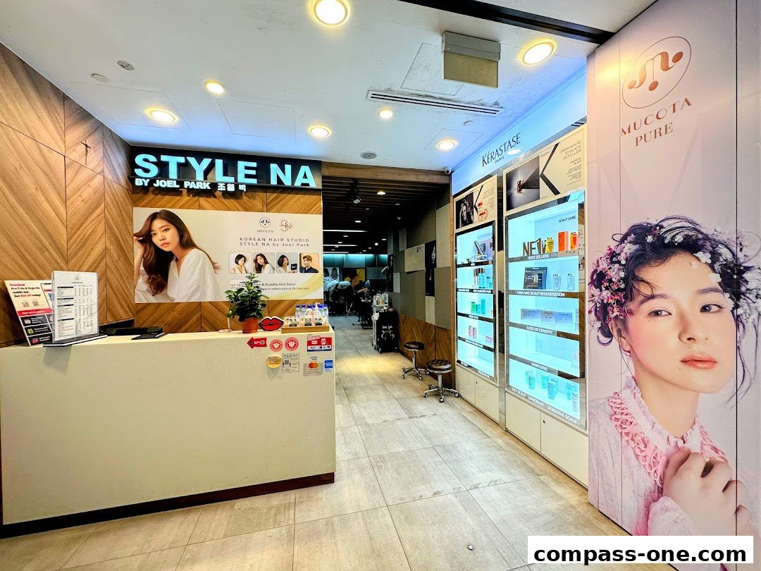 Interior view of a modern hair salon with a reception desk and product displays.