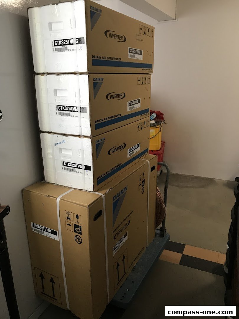A stack of Daikin air conditioner boxes on a trolley, ready for delivery or installation.