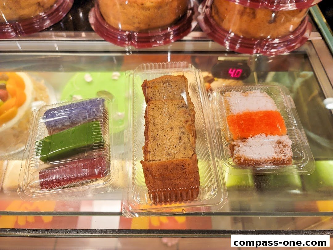 A display case filled with various sweet treats, including cakes and colorful jellies.