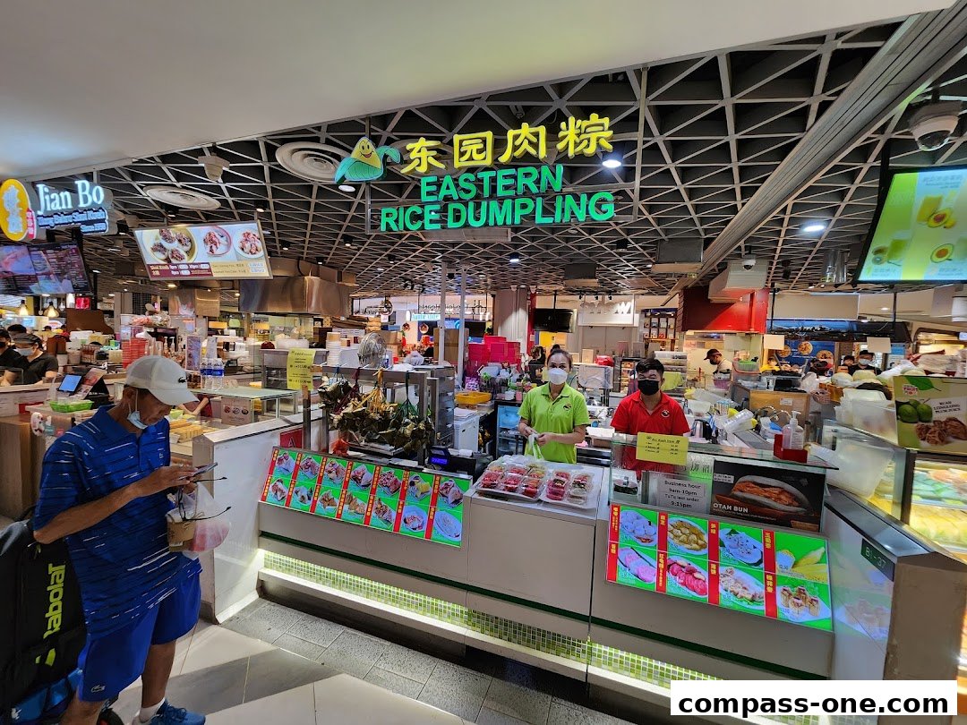 Eastern Rice Dumpling shop with staff serving customers and displaying various food items.