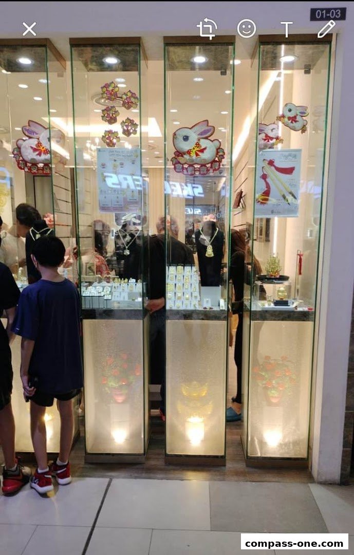 A jewelry shop display featuring gold necklaces, rings, and decorative rabbits.