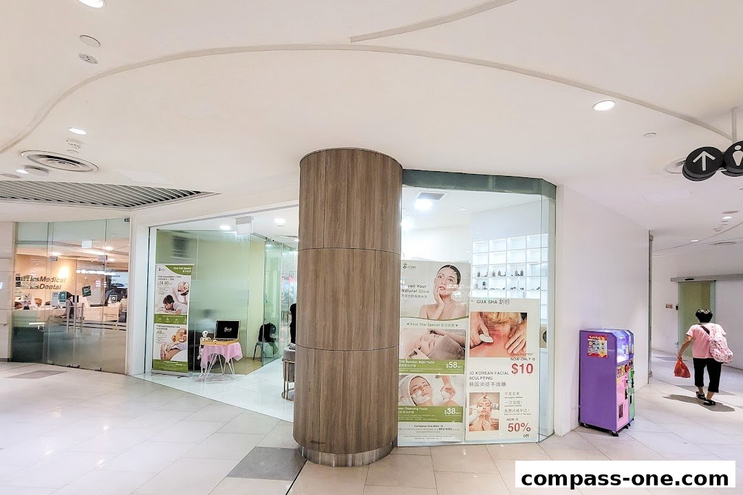 The entrance of Joyre TCMedi Spa with promotional posters and a wooden pillar.