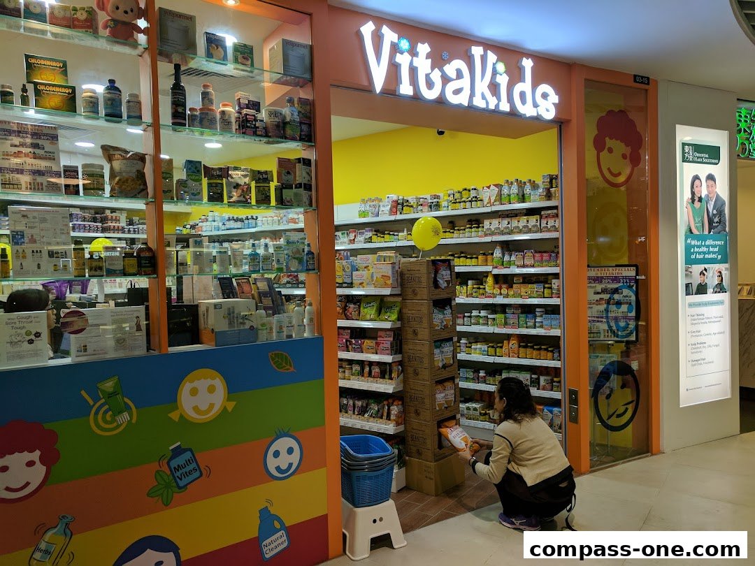 The entrance of VitaKids, a shop selling health and wellness products, with shelves stocked with items.