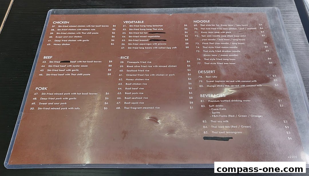 A menu from Nakhon Kitchen featuring Thai dishes, including chicken, beef, pork, vegetables, noodles, rice, desserts, and beverages.